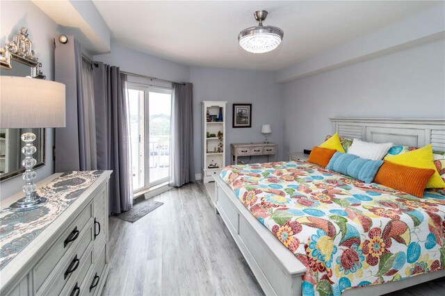 bedroom featuring access to outside and light wood-type flooring