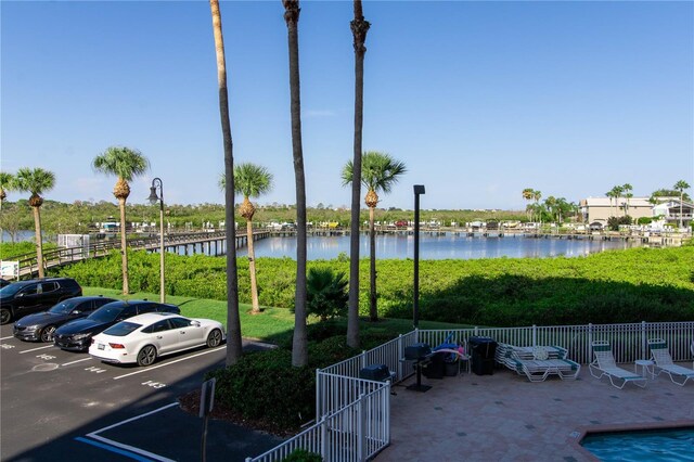 view of car parking with a water view