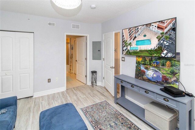 sitting room with light hardwood / wood-style flooring and electric panel