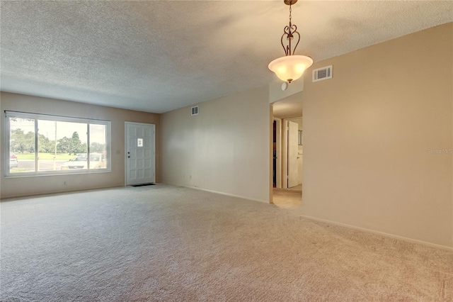 carpeted spare room featuring a textured ceiling