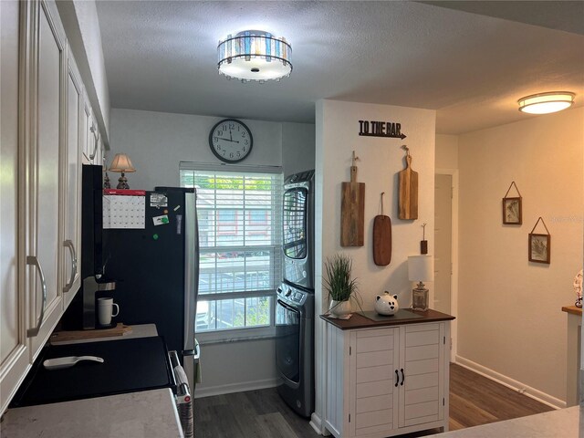 kitchen featuring dark hardwood / wood-style flooring, stove, white cabinets, and black oven