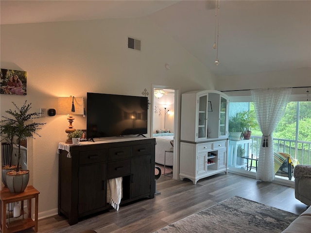 living room featuring dark hardwood / wood-style floors and high vaulted ceiling