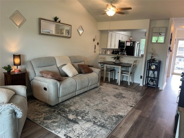 living room featuring ceiling fan and dark hardwood / wood-style flooring