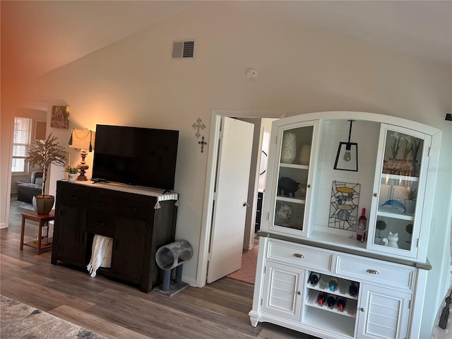 living room with dark wood-type flooring and vaulted ceiling