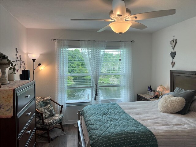 bedroom featuring dark hardwood / wood-style flooring and ceiling fan