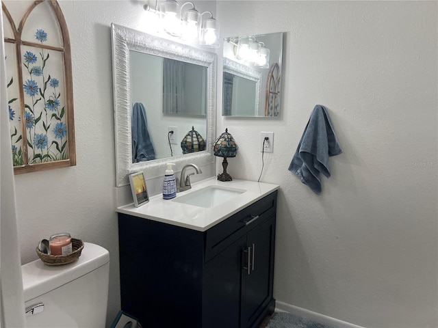 bathroom featuring toilet and vanity