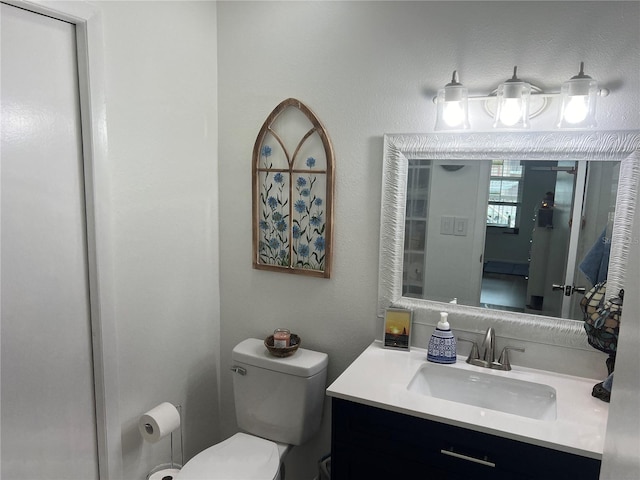 bathroom with toilet and vanity