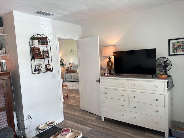 bedroom featuring hardwood / wood-style flooring and a textured ceiling