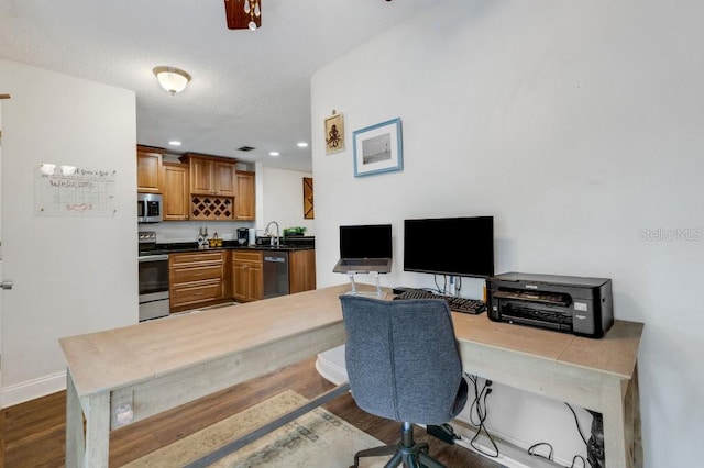 office area featuring dark hardwood / wood-style flooring and sink