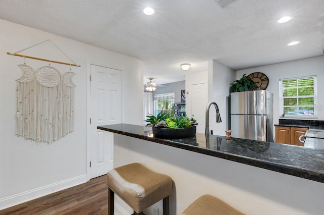 kitchen with plenty of natural light, sink, dark wood-type flooring, and stainless steel refrigerator