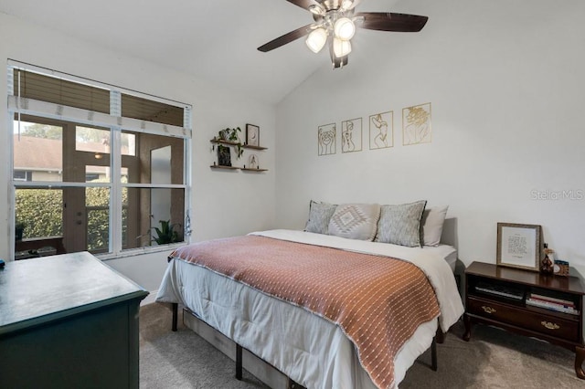 carpeted bedroom with ceiling fan and vaulted ceiling