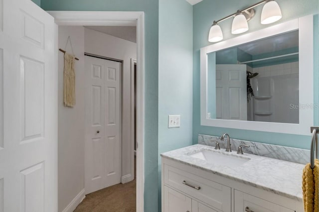 bathroom featuring a shower and vanity