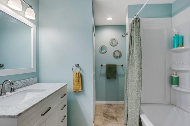 bathroom featuring vanity and shower / bath combination with curtain