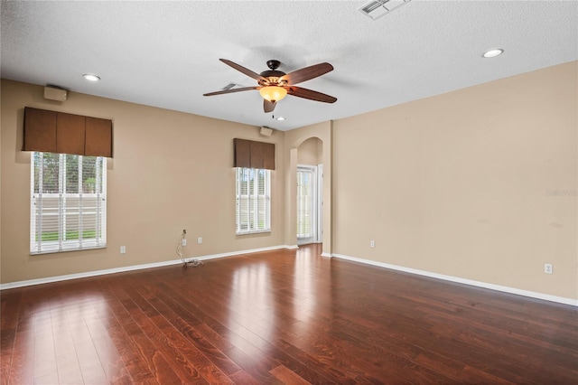 spare room with ceiling fan, dark hardwood / wood-style floors, and a textured ceiling