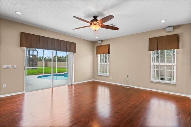 spare room featuring ceiling fan, a textured ceiling, and wood-type flooring