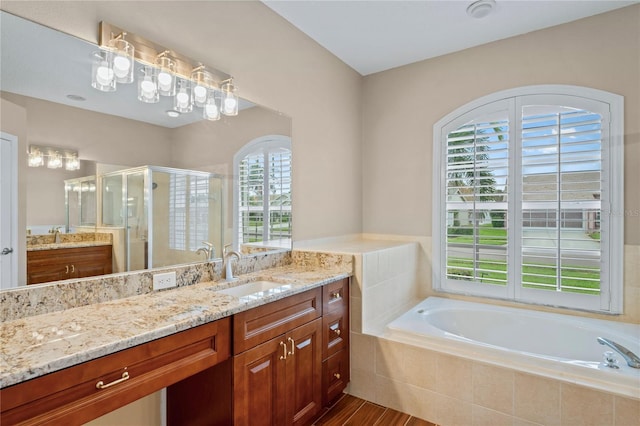 bathroom with vanity, shower with separate bathtub, and hardwood / wood-style floors