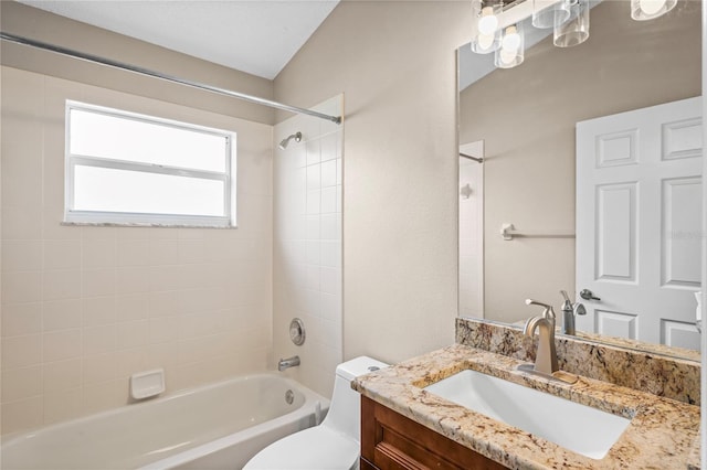 full bathroom featuring vanity, toilet, and tiled shower / bath combo