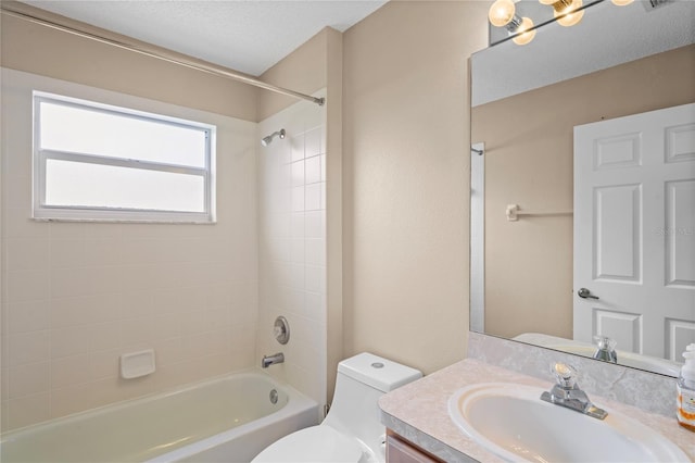 full bathroom featuring vanity,  shower combination, a textured ceiling, and toilet