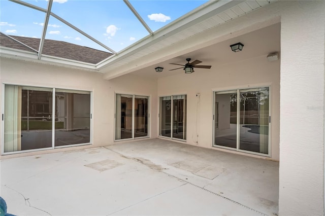 view of patio with ceiling fan and a lanai