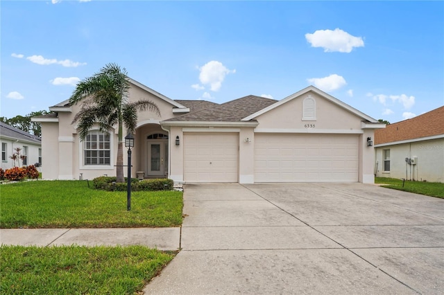 ranch-style home with a garage and a front lawn