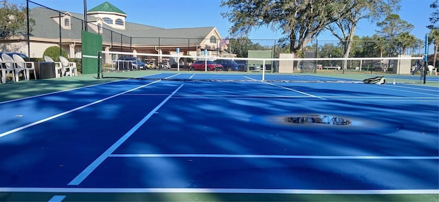 view of tennis court featuring basketball court