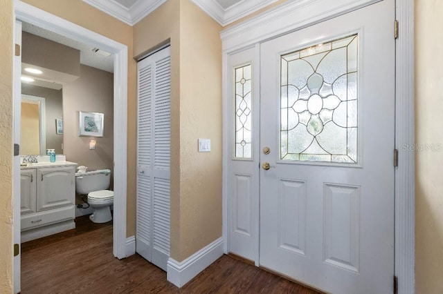 entrance foyer with crown molding, sink, and dark hardwood / wood-style flooring