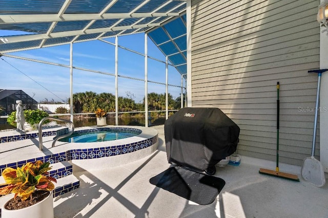 view of patio / terrace featuring a lanai, grilling area, and an in ground hot tub