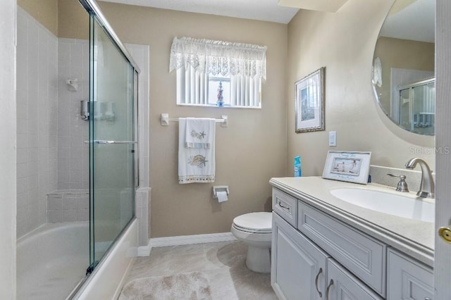 full bathroom featuring enclosed tub / shower combo, vanity, and toilet