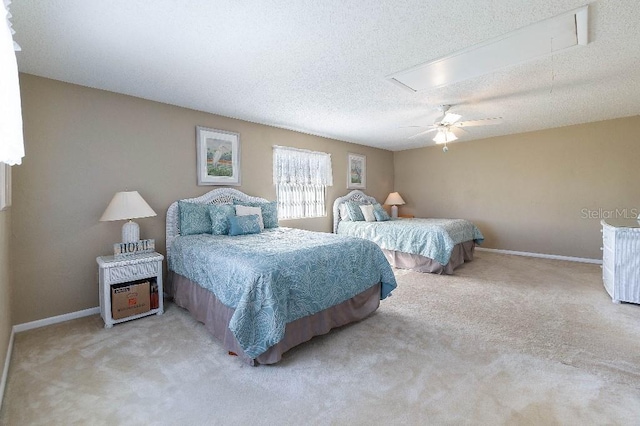 bedroom with ceiling fan, light carpet, and a textured ceiling