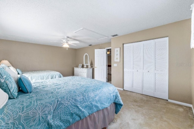 carpeted bedroom with a textured ceiling and ceiling fan