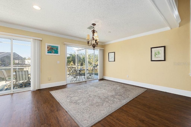 unfurnished dining area featuring crown molding, dark hardwood / wood-style floors, a wealth of natural light, and a textured ceiling