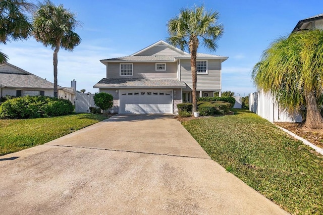 view of property featuring a garage and a front yard