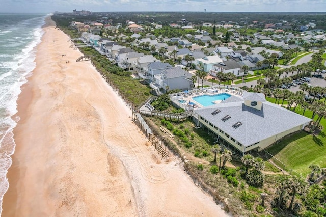 birds eye view of property featuring a water view and a view of the beach