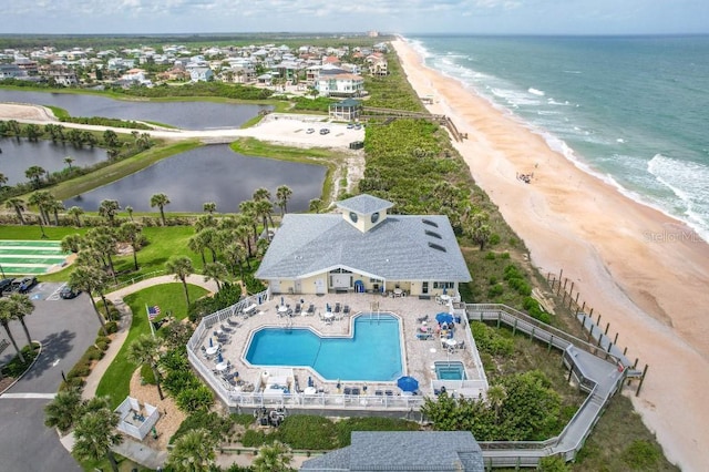 bird's eye view featuring a water view and a beach view