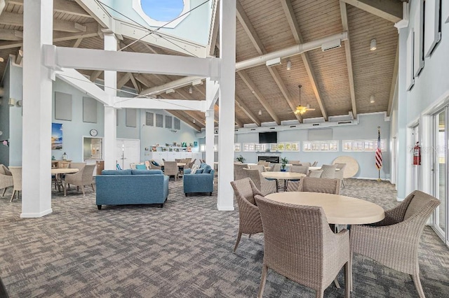 dining space featuring carpet flooring, high vaulted ceiling, beam ceiling, and wooden ceiling