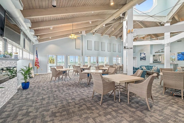 interior space featuring beam ceiling, high vaulted ceiling, decorative columns, and wooden ceiling