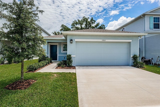 view of front facade with a front yard and a garage