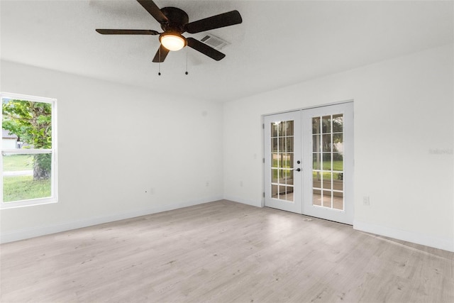 empty room featuring ceiling fan, light hardwood / wood-style flooring, and french doors