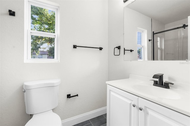 bathroom with vanity, toilet, and tile patterned flooring