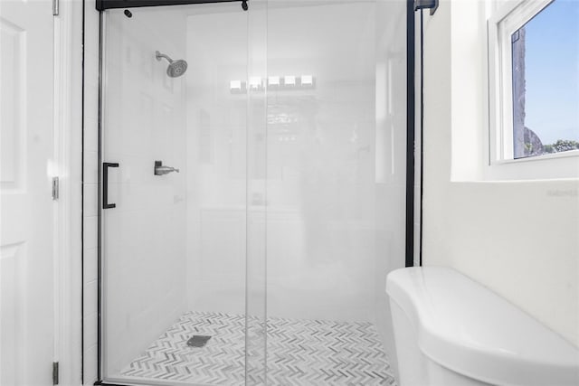 bathroom with a shower with door