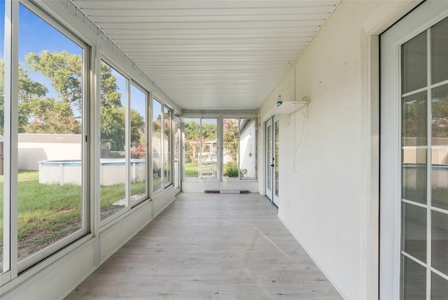 unfurnished sunroom featuring plenty of natural light