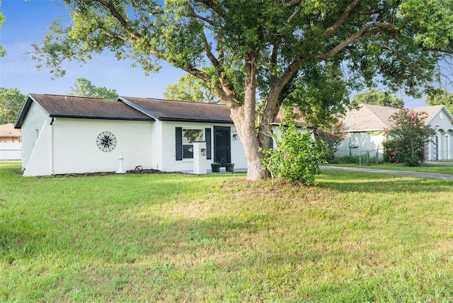 ranch-style home with a front lawn