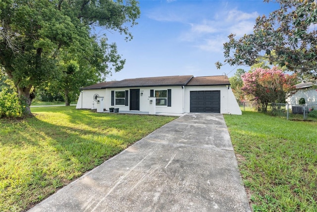 ranch-style house with a garage and a front lawn