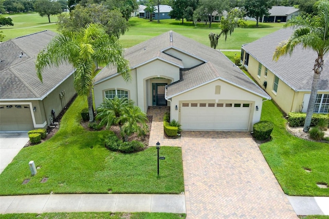 view of front of house with a garage and a front yard