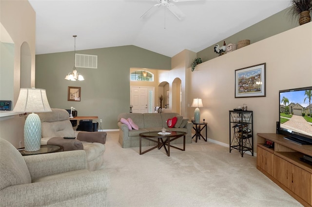 carpeted living room featuring lofted ceiling and ceiling fan with notable chandelier