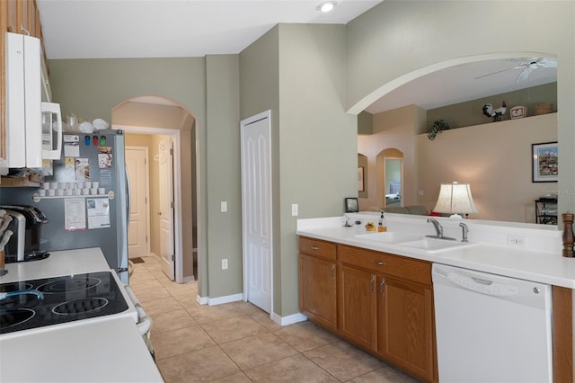 kitchen with sink, light tile patterned floors, dishwasher, ceiling fan, and stove