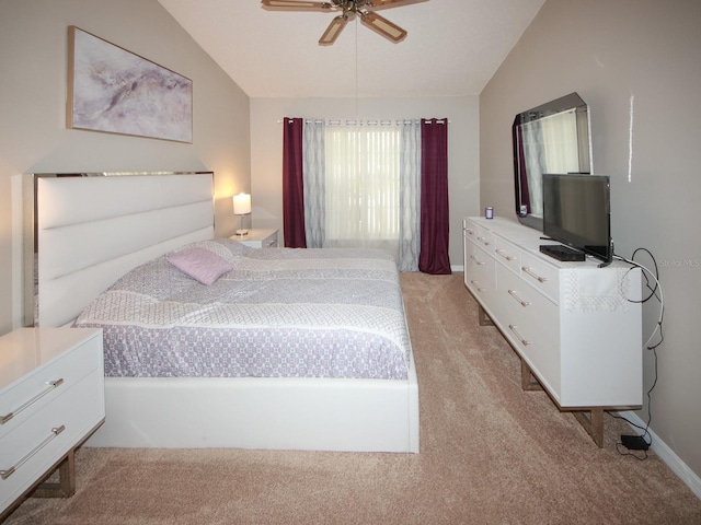 carpeted bedroom featuring ceiling fan and vaulted ceiling