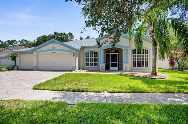 single story home with a front yard and a garage