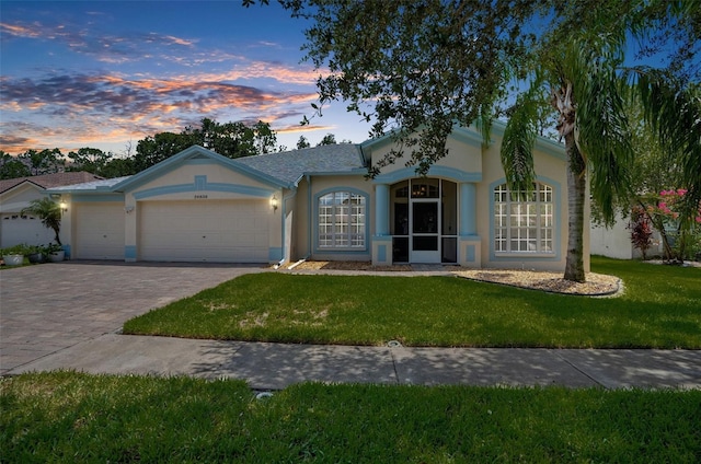 ranch-style home with a lawn and a garage