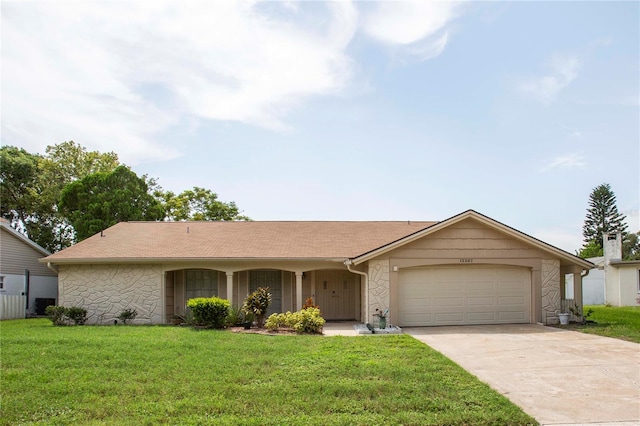 ranch-style home featuring a front lawn and a garage